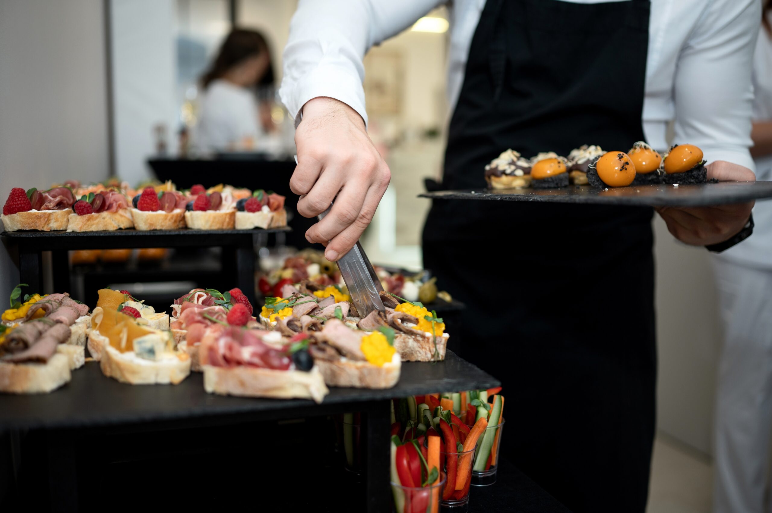 Cook,Puts,Snacks,On,Table.,Catering.,Festive,Buffet.,Table,Setting.
